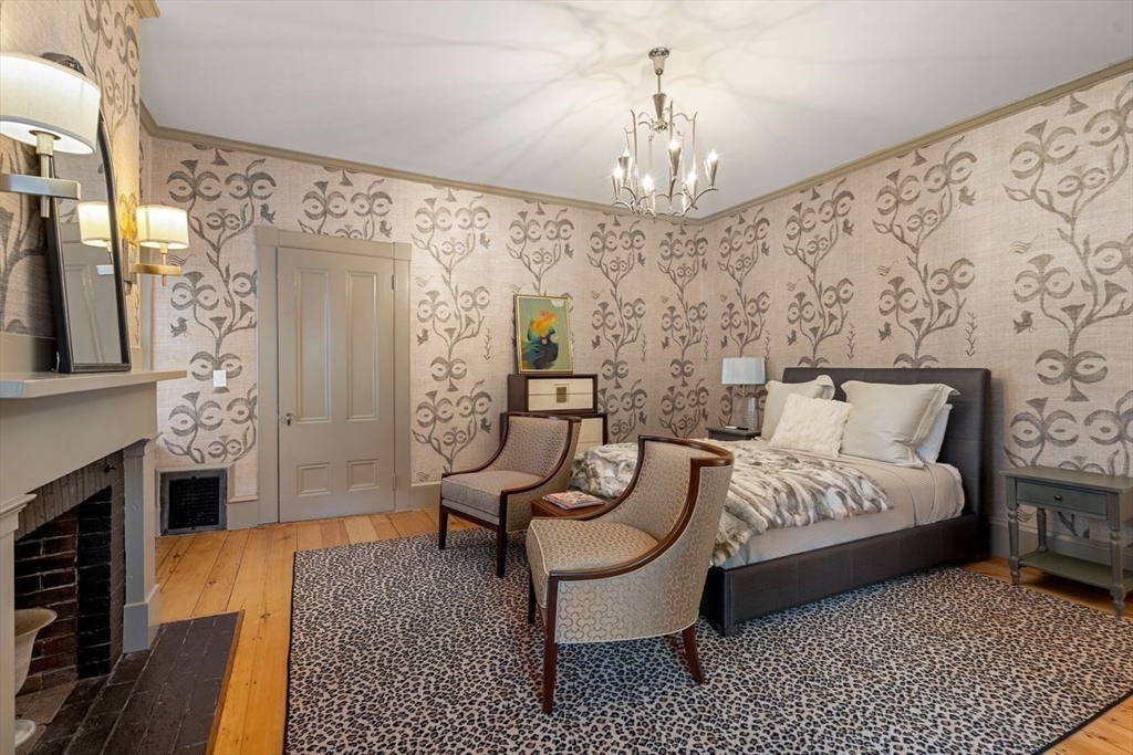 38 Chestnut Street Salem, MA 01970 - Photo 29 of 41 a spacious bedroom with bed and a chandelier
