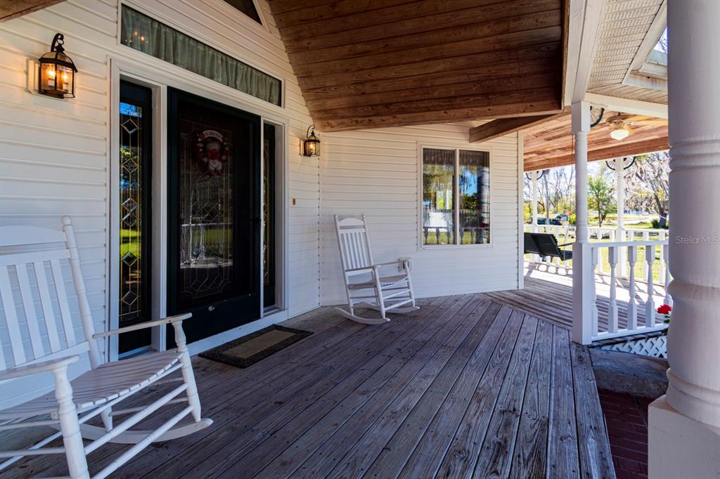 9215 Ridge Road New Port Richey, FL 34654 - Photo 2 of 71 a view of a porch with wooden floor and outdoor space