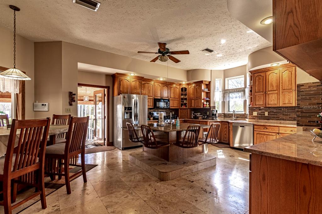 9215 Ridge Road New Port Richey, FL 34654 - Photo 27 of 71 a view of a dining room with furniture