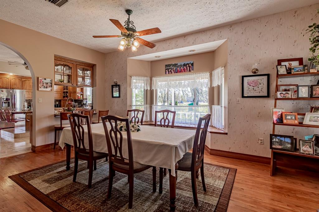 9215 Ridge Road New Port Richey, FL 34654 - Photo 34 of 71 a view of a dining room with furniture window and wooden floor