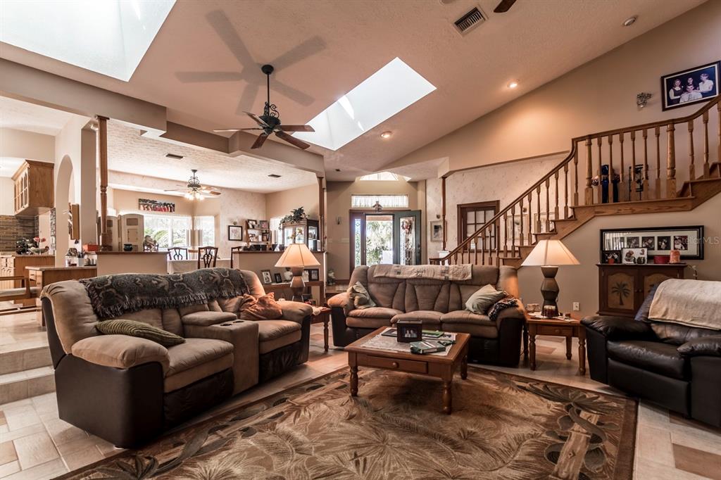 9215 Ridge Road New Port Richey, FL 34654 - Photo 37 of 71 a living room with furniture ceiling fan and a rug
