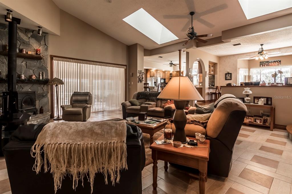 9215 Ridge Road New Port Richey, FL 34654 - Photo 38 of 71 a bed room with furniture a flat screen tv and a window