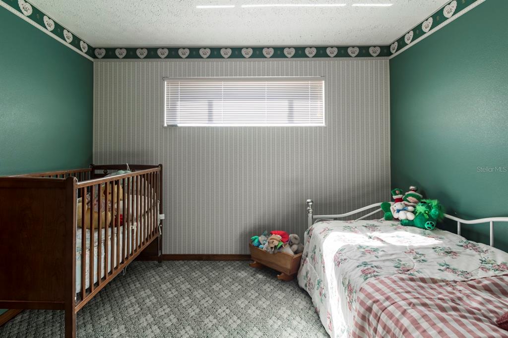 9215 Ridge Road New Port Richey, FL 34654 - Photo 54 of 71 a bedroom with a bed and a window