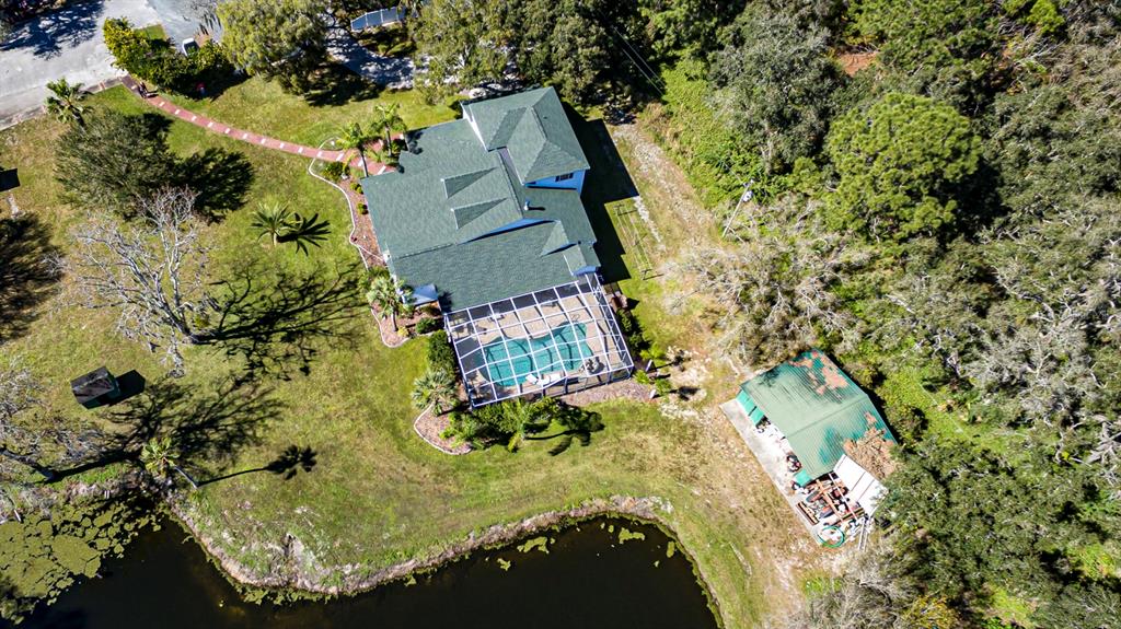 9215 Ridge Road New Port Richey, FL 34654 - Photo 59 of 71 an aerial view of a house with a yard and swimming pool