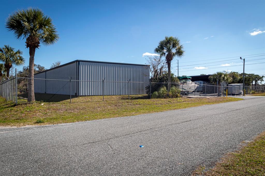 9215 Ridge Road New Port Richey, FL 34654 - Photo 64 of 71 a view of large house with a yard and potted plants