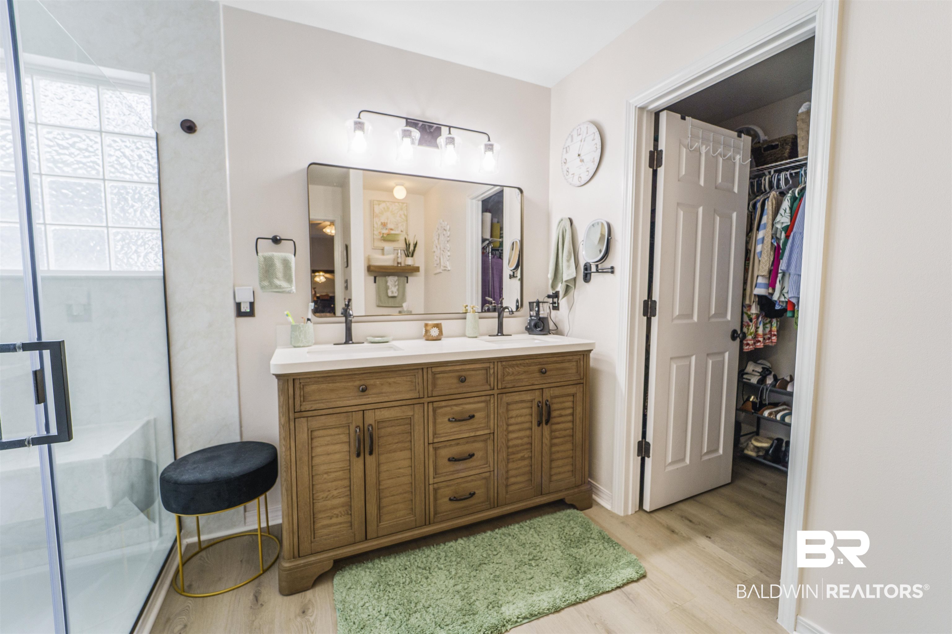 4620 Pine Boulevard Orange Beach, AL 36561 - Photo 18 of 49 Full bathroom with wood finished floors, double vanity, a stall shower, and a spacious closet