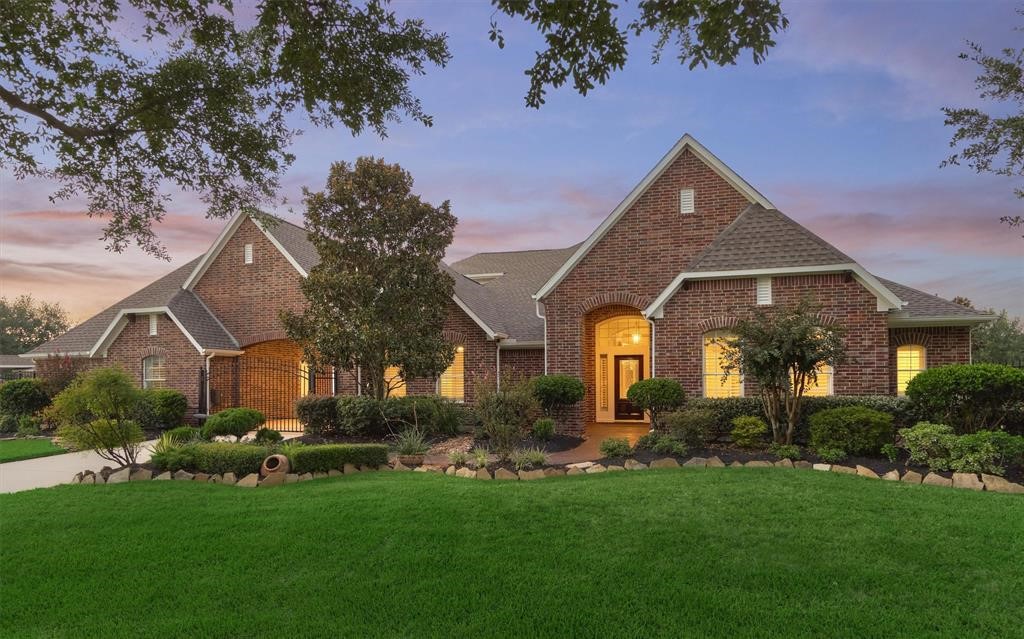a front view of house with a garden