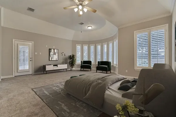 a spacious bedroom with a bed a couch and large windows