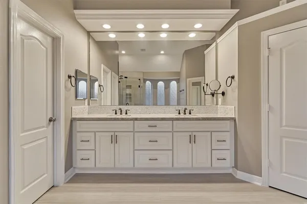 a spacious bathroom with a granite countertop sink a mirror and a