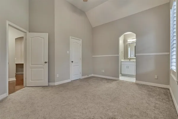 a bathroom with a bathtub sink vanity and mirror