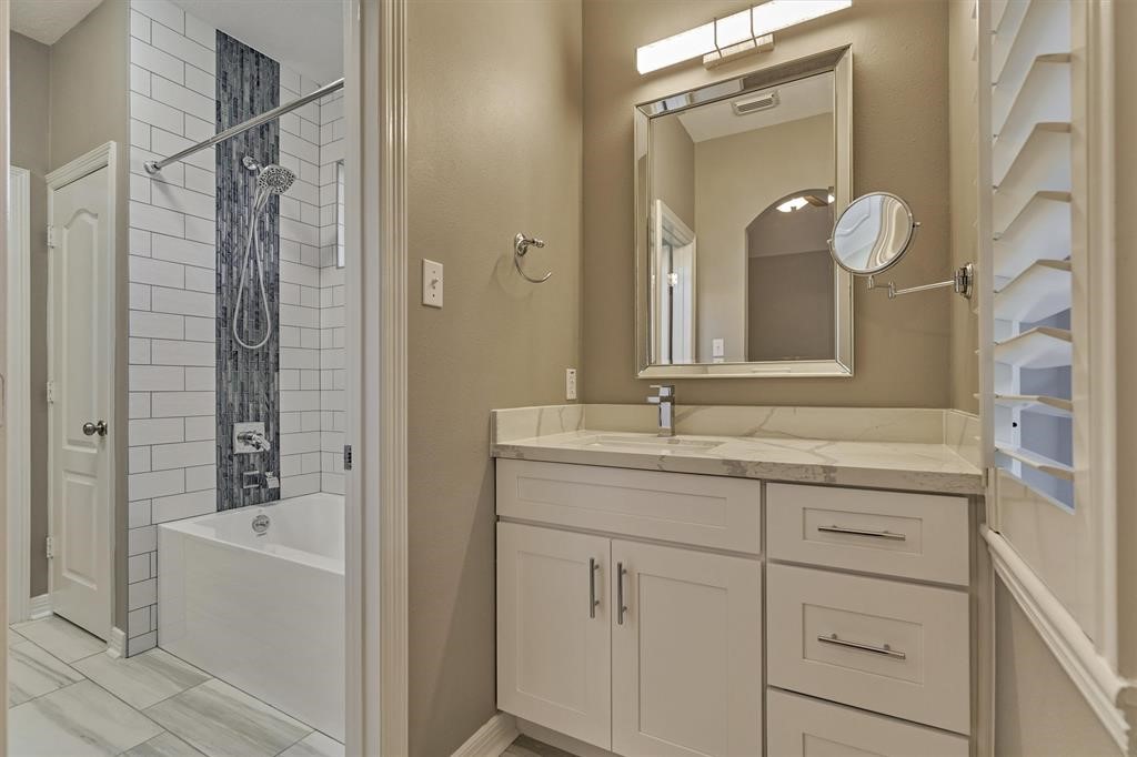 20806 East Cameron Ridge Drive Cypress, TX 77433 - Photo 21 of 45 a bathroom with a bathtub sink vanity and mirror