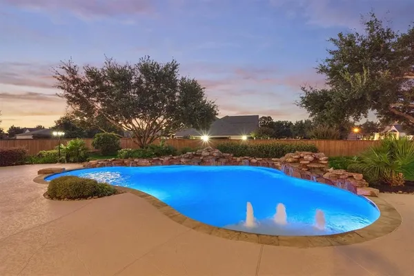 a view of a swimming pool with an outdoor space and seating area
