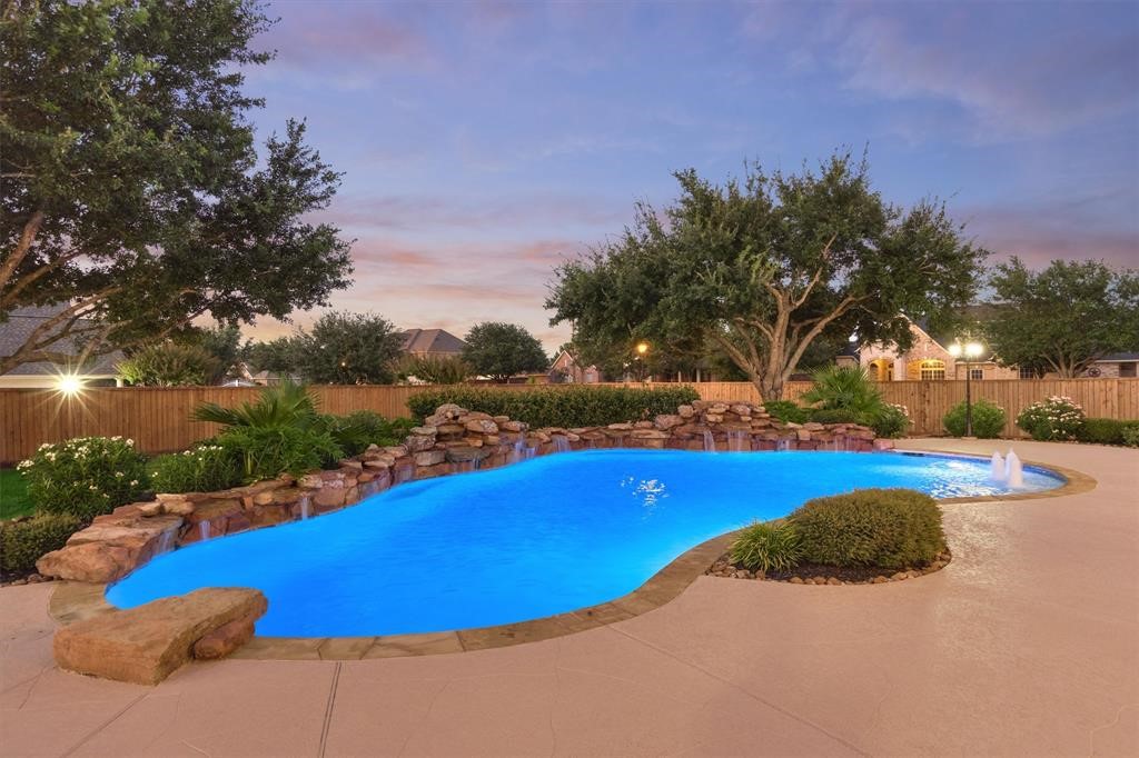 20806 East Cameron Ridge Drive Cypress, TX 77433 - Photo 35 of 45 a view of a swimming pool with an outdoor space and seating area