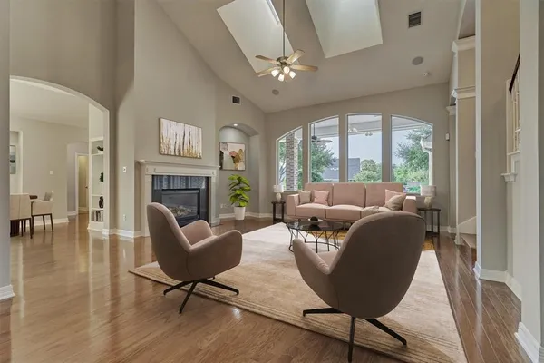 a living room with furniture a large window and a fireplace