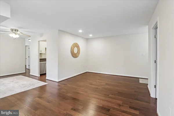 a view of a room with wooden floor and mirror