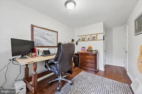 a view of a workspace with furniture and wooden floor