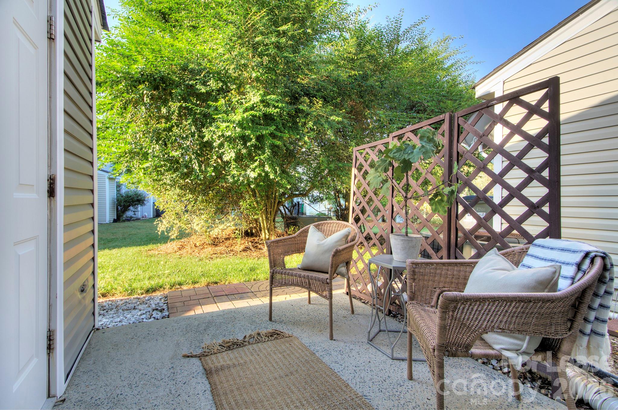 8268 Golf Ridge Drive Charlotte, NC 28277 - Photo 15 of 24 a view of a patio with couple of chairs and a fire pit