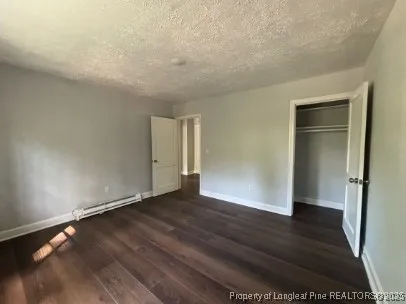 a view of an empty room and wooden floor