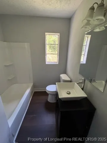 a bathroom with a sink a toilet and bathtub