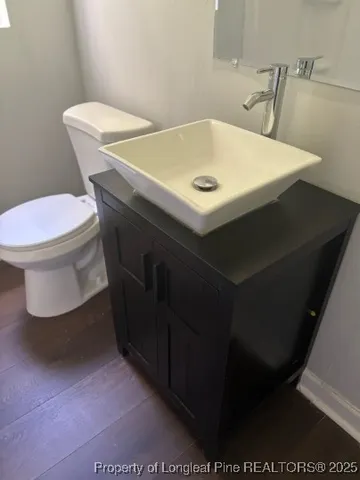 a bathroom with a sink toilet and a mirror