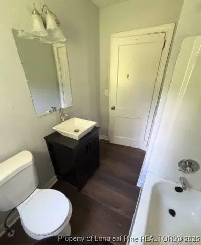 a bathroom with a sink a toilet and mirror