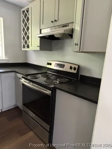 a kitchen with stainless steel appliances a stove a microwave and cabinets
