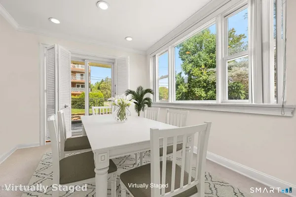 a view of a dining room with furniture and wooden floor