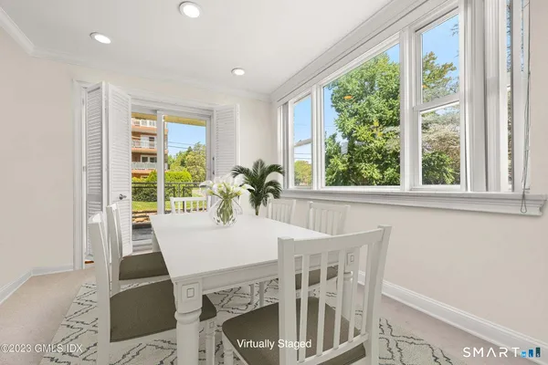 a view of a dining room with furniture window and outside view