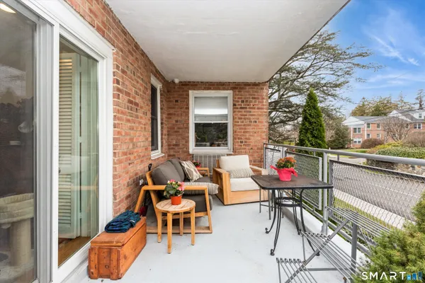 a balcony with table and chairs