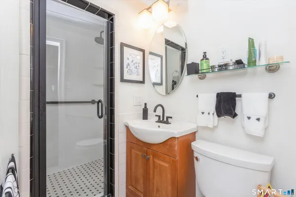 a bathroom with a sink toilet and shower