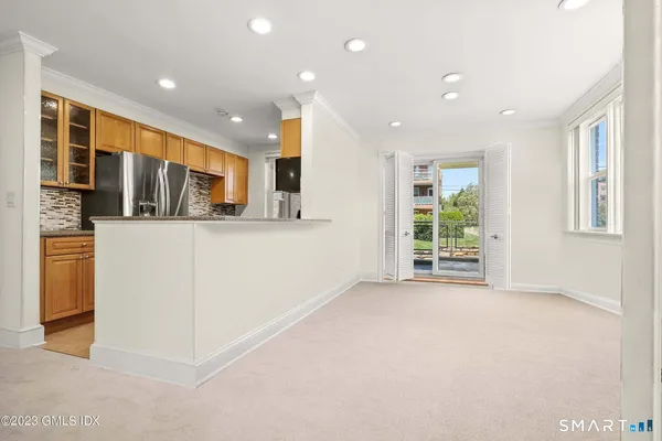 a view of a kitchen with stainless steel appliances granite countertop cabinets and a window