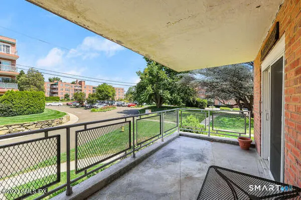 a view of balcony with two large trees