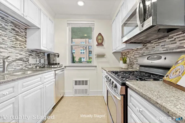 a kitchen with stainless steel appliances granite countertop a stove and a sink