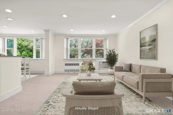 a living room with furniture and a large window