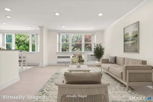 a living room with furniture and a large window