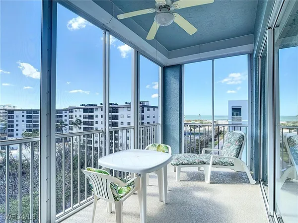 a balcony with furniture and a potted plant