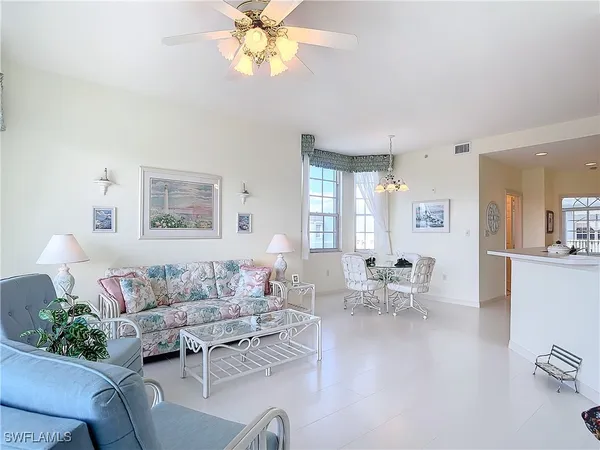 a dining room with furniture and chandelier kitchen view