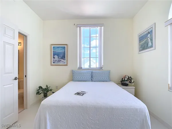 a bedroom with a bed and hallway
