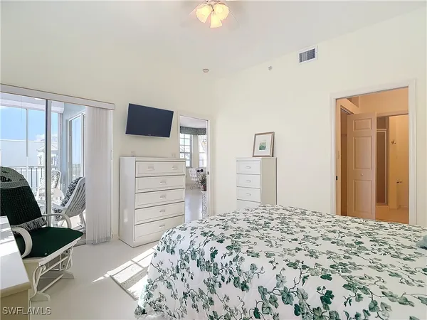 a bedroom with a bed and a television