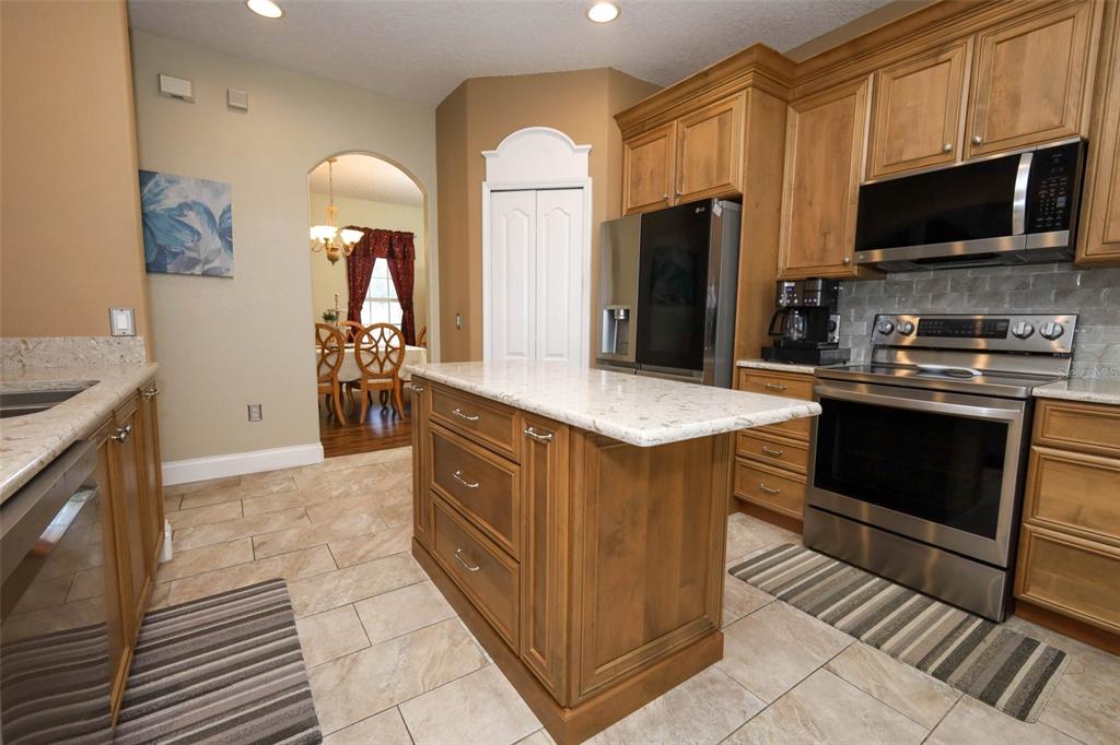 3222 Merrick Avenue Rockledge, FL 32955 - Photo 13 of 73 a kitchen with stainless steel appliances granite countertop a stove a sink and a refrigerator