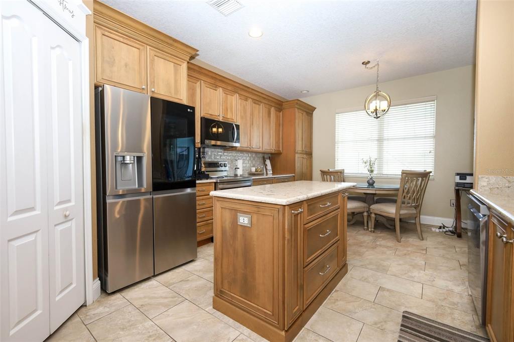 3222 Merrick Avenue Rockledge, FL 32955 - Photo 14 of 73 a kitchen with a refrigerator a sink a counter top space and cabinets