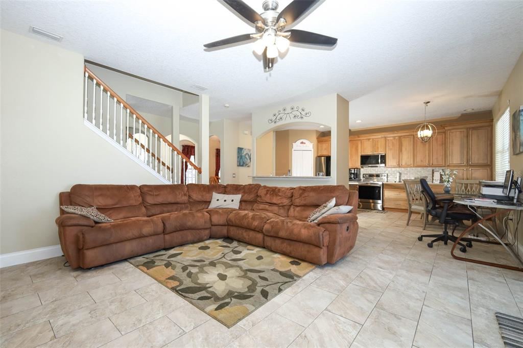 3222 Merrick Avenue Rockledge, FL 32955 - Photo 17 of 73 a living room with furniture kitchen view and a chandelier