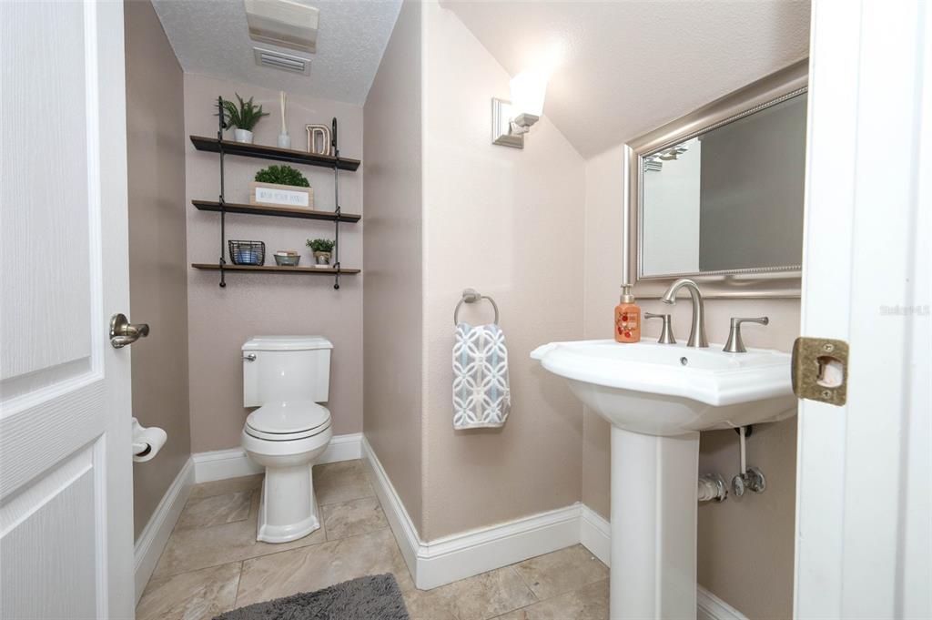 3222 Merrick Avenue Rockledge, FL 32955 - Photo 21 of 73 a bathroom with a sink a toilet and a mirror
