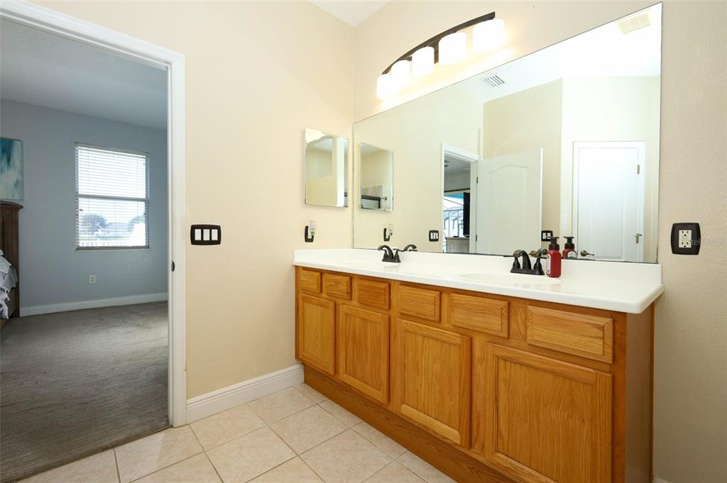 3222 Merrick Avenue Rockledge, FL 32955 - Photo 27 of 73 a spacious bathroom with a double vanity sink mirror and