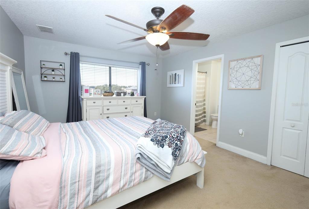 3222 Merrick Avenue Rockledge, FL 32955 - Photo 31 of 73 a bedroom with a bed and a chandelier