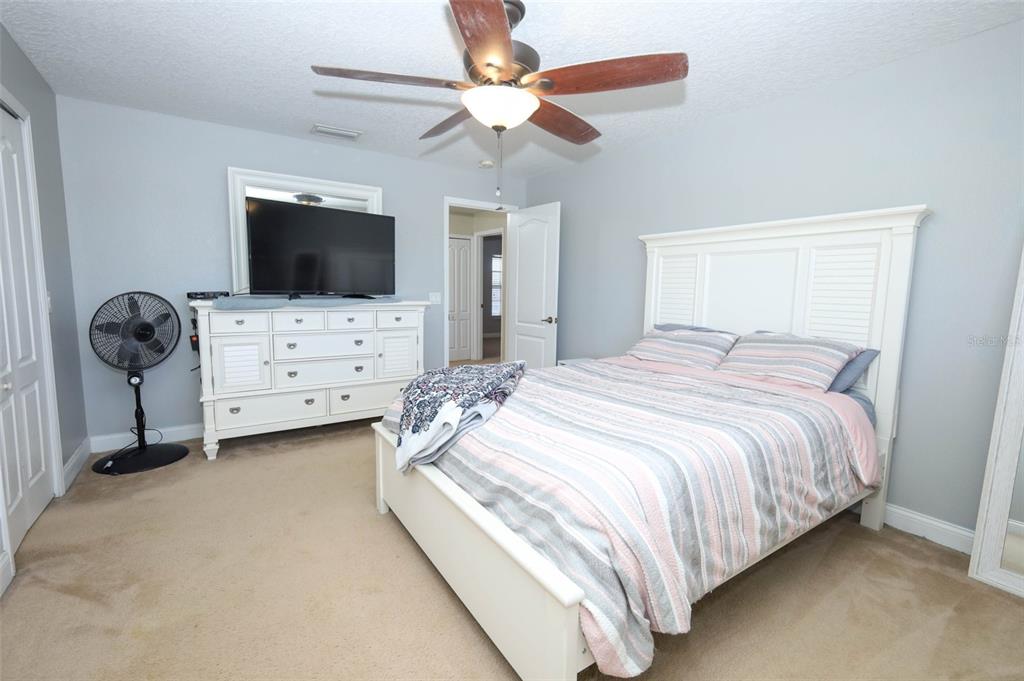 3222 Merrick Avenue Rockledge, FL 32955 - Photo 34 of 73 a bedroom with a bed and a flat tv screen on dresser