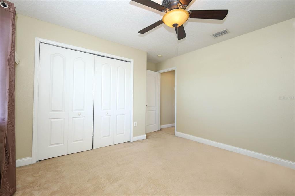 3222 Merrick Avenue Rockledge, FL 32955 - Photo 41 of 73 an empty room with windows and fan