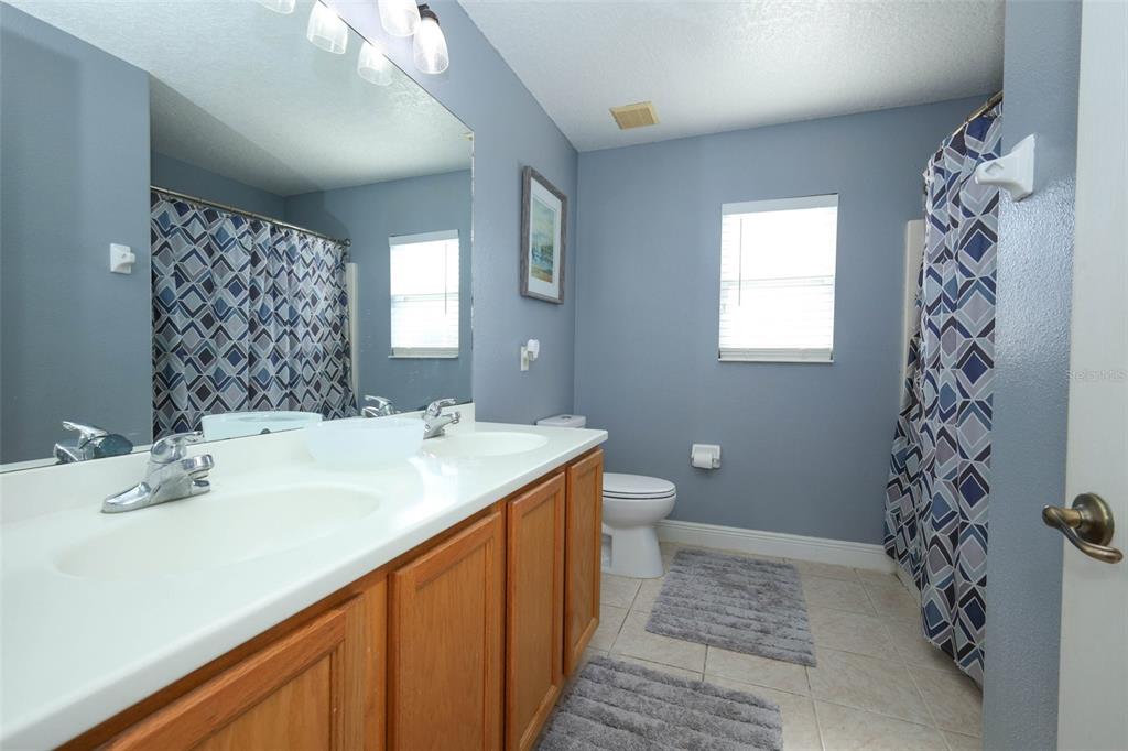 3222 Merrick Avenue Rockledge, FL 32955 - Photo 42 of 73 a bathroom with a sink a toilet and shower