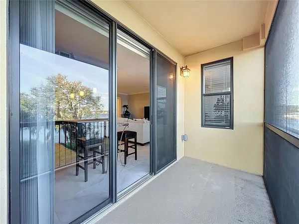 a view of a hallway to a livingroom with furniture and front door