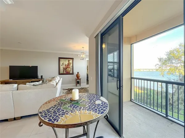 a living room with furniture a flat screen tv and a table